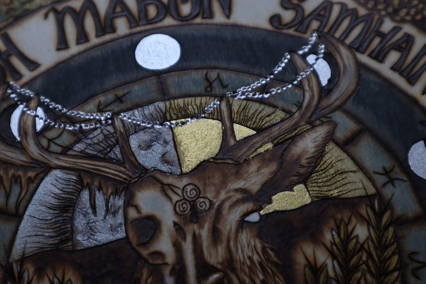 Witchy mabon autumn equinox wheel of the year for pagan altar woodburned decor with gourds, candles, sunflowers, apples, fall leaves.