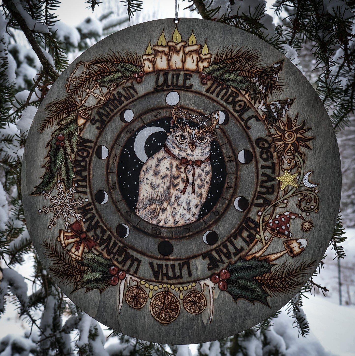 Woodburned wheel of the year for yule witchmas for the pagan season with snowy owl and moon phases, astrological symbols for pagan and witches and wiccans by www.smokecrafthollow.com