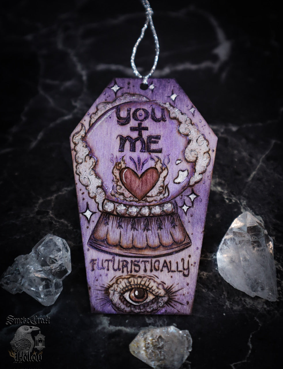 Spooky cute gothic witchy valentine’s day woodburned art decor on wooden casket coffin ornament hanging with crystal ball, heart, and all seeing eye. Handmade by Smokecraft Hollow