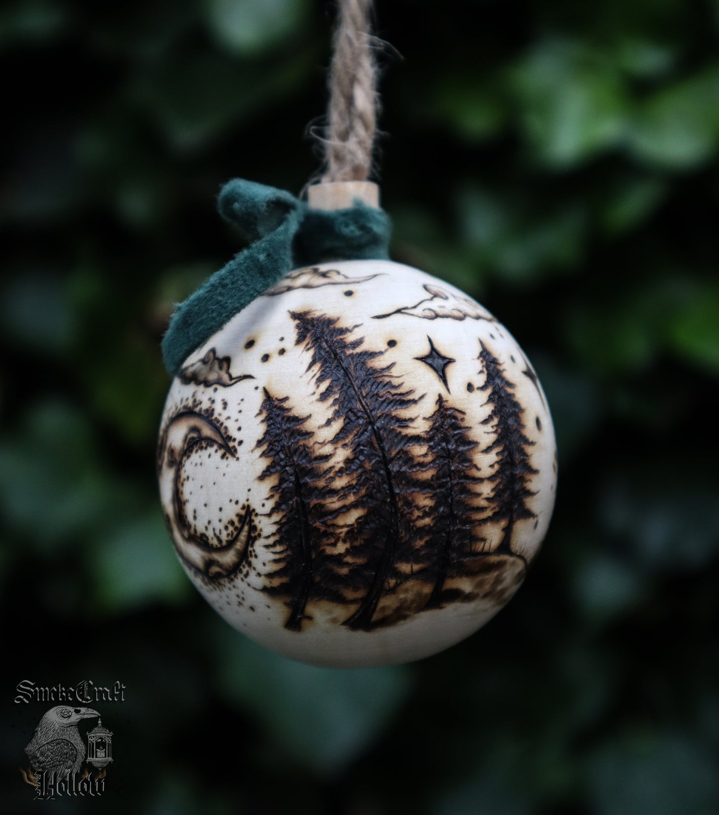Pagan yule wooden bauble tree ornament with triple goddess symbol and woodland scene complete withe velvet green bow, clouds, and stars for witchmas home decor.