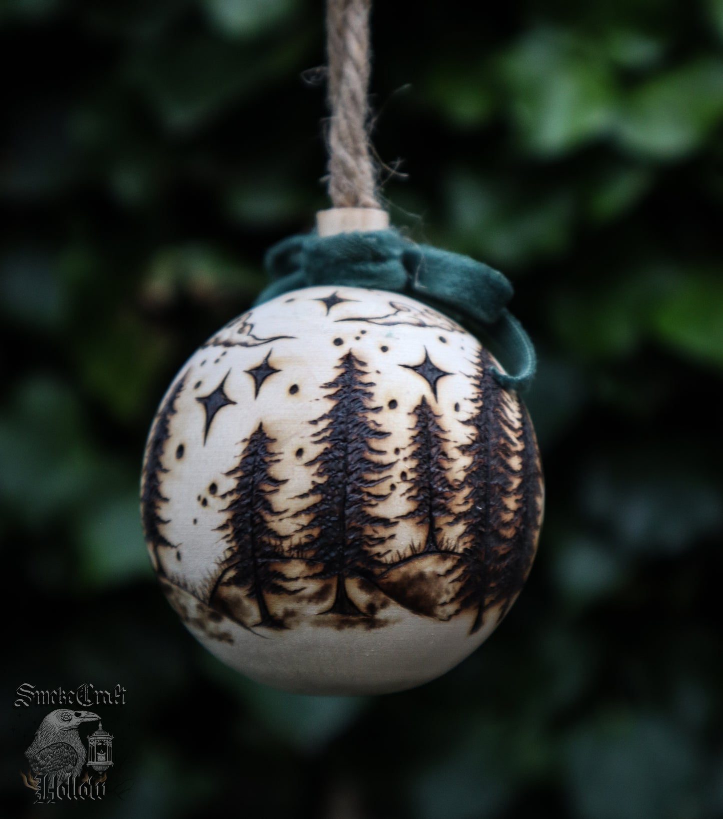 Pagan yule wooden bauble tree ornament with triple goddess symbol and woodland scene complete withe velvet green bow, clouds, and stars for witchmas home decor.