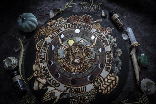 This witchy woodburned wheel of the year is handcrafted to include imagery that invokes the themes of Lughnasadh such as a Highland cow, rainbow corn, scythe, wheat, bread, runes, corn dolly, hops, honey, etc while also including moon phases, astrological symbols, and the sabbath's of the pagan year. Handpained, this wheel of the year also includes sparkly metallic accents which grab the light from across the room. Add this wheel of the year to your space or altar to celebrate the celtic pagan season.