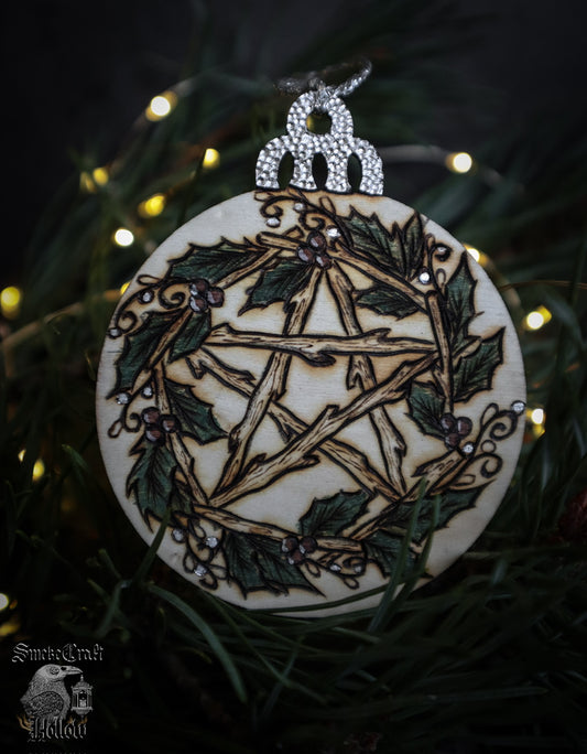 Adorn your Yule tree with this pentagram wreath witchmas woodburned bauble ornament &nbsp;measuring 7cm with sparkly silver hanging twine, and silver accents. This pagan winter solstice bauble is sure to add magick to your tree and remind everyone that pagans are the reason for the season!

Hand pyrography in Suffolk, U.K.&nbsp;
Www.smokecrafthollow.com