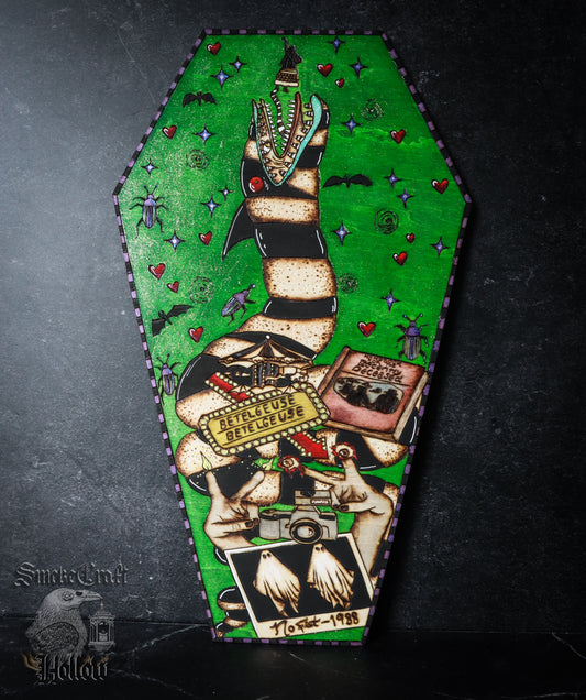 Beetle Juice, including: sandworm, Lydia, ghosts, Polaroid, camera, sign, beetles, hearts, etc. Handcrafted on coffin shaped cut of &nbsp;basswood in 5 hours, this is the perfect spooky addition for Halloween or all year round, especially fans of Tim Burton. &nbsp;Measures 28cm at the tallest point.