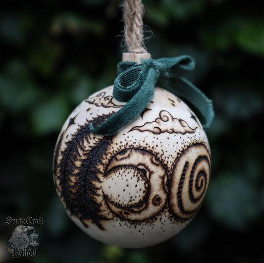 Pagan yule wooden bauble tree ornament with triple goddess symbol and woodland scene complete withe velvet green bow, clouds, and stars for witchmas home decor.